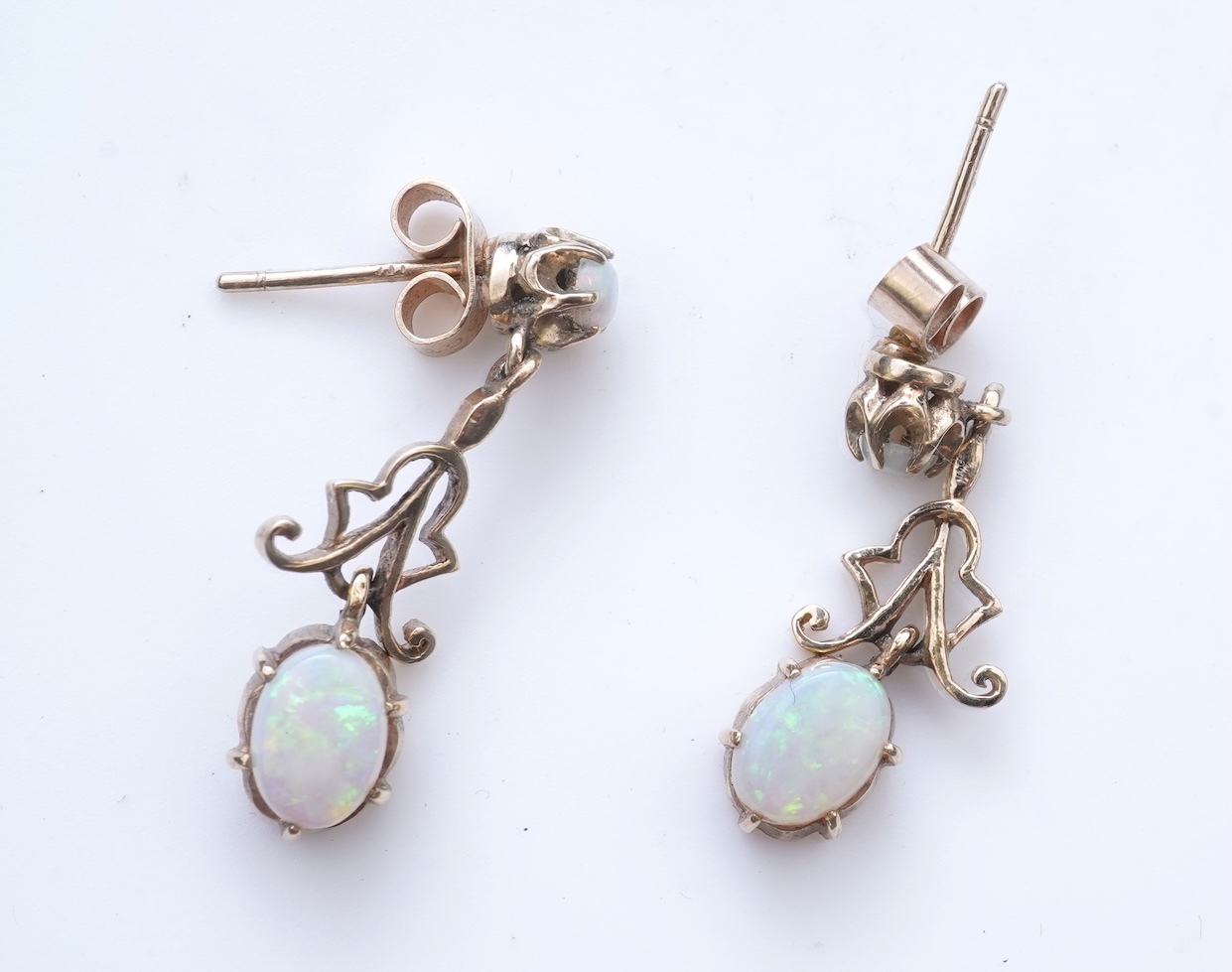 Eight pairs of earrings and pendant, comprising: a pair of onyx studs; a pair of emerald studs; a pair of sapphire and diamond drop earrings; a pair of opal drop earrings; a pair of garnet drop earrings; and a shell pend